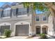 Attractive townhome showcasing architectural details, a well-manicured lawn, and inviting entryway at 10212 Westpark Preserve Blvd, Tampa, FL 33625
