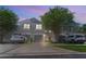 Charming townhome with a well-maintained exterior, driveway, and lush landscaping under twilight at 10212 Westpark Preserve Blvd, Tampa, FL 33625