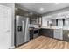 Well-lit kitchen featuring stainless steel appliances and dark cabinets at 10212 Westpark Preserve Blvd, Tampa, FL 33625