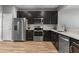 Modern kitchen features stainless steel appliances, dark cabinetry, and light countertops at 10212 Westpark Preserve Blvd, Tampa, FL 33625