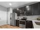 Well-lit kitchen with stainless steel appliances and dark cabinets at 10212 Westpark Preserve Blvd, Tampa, FL 33625