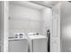 Bright laundry area features modern appliances and convenient shelving for storage solutions at 10212 Westpark Preserve Blvd, Tampa, FL 33625