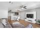 Open-concept living room featuring wood floors, media center, and modern dining area, great for entertaining at 10212 Westpark Preserve Blvd, Tampa, FL 33625