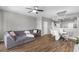Spacious living room with hardwood floors, gray walls and a large comfortable sectional sofa, perfect for gatherings at 10212 Westpark Preserve Blvd, Tampa, FL 33625