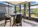 Enclosed patio with seating provides a cozy outdoor living space with neighborhood views at 10212 Westpark Preserve Blvd, Tampa, FL 33625