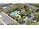 Aerial shot of community pool, palm trees, lounge seating, and nearby townhomes at 10212 Westpark Preserve Blvd, Tampa, FL 33625