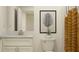 Neutral bathroom with white cabinets, white marble countertop, and decorative nature-themed artwork at 10865 Rustic Eve Ct, Land O Lakes, FL 34638