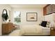 Bright bedroom featuring a comfortable bed, dresser, art, and serene view at 10865 Rustic Eve Ct, Land O Lakes, FL 34638