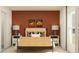 Modern bedroom design with accent wall, stylish lamps, and neutral color scheme at 10865 Rustic Eve Ct, Land O Lakes, FL 34638