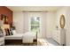 Bright bedroom with white walls, patterned rug, a dresser and a view of nature through the window at 10865 Rustic Eve Ct, Land O Lakes, FL 34638