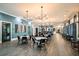 Open clubhouse interior features stylish decor, tables, chairs, bar area, hardwood floors, and natural light at 10865 Rustic Eve Ct, Land O Lakes, FL 34638