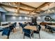 Elegant game room with coffered ceilings, chandelier lighting and blue velvet seating at 10865 Rustic Eve Ct, Land O Lakes, FL 34638