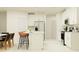 Bright, modern kitchen with white cabinetry, stainless steel appliances, and island seating at 10865 Rustic Eve Ct, Land O Lakes, FL 34638