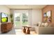 Cozy living room with large windows, modern furniture, and bright natural light at 10865 Rustic Eve Ct, Land O Lakes, FL 34638