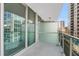 Condo balcony featuring city views, glass railings, and a sliding glass door that brings the outside in at 111 N 12Th St # 1502, Tampa, FL 33602