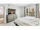 Bright bedroom with a large window that offers city views, plus a dresser with a TV at 111 N 12Th St # 1502, Tampa, FL 33602