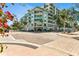 Contemporary building exterior with balconies, mature trees and a corner view on a sunny day at 111 N 12Th St # 1502, Tampa, FL 33602