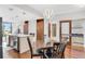 Modern dining room with a unique lighting fixture, wood floors, island with beverage cooler, and cabinets at 111 N 12Th St # 1502, Tampa, FL 33602