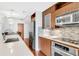 Well-equipped kitchen featuring stainless steel appliances, tile backsplash, and wooden cabinetry at 111 N 12Th St # 1502, Tampa, FL 33602