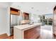 Bright, modern kitchen island with stainless steel appliances and an open floor plan with dining and living area at 111 N 12Th St # 1502, Tampa, FL 33602