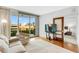 Bright living room with hardwood floors, city views, and sliding door access to a private balcony at 111 N 12Th St # 1502, Tampa, FL 33602