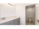 Modern bathroom with gray vanity and toilet; bright and clean space at 12466 Gust Ct, Hudson, FL 34669