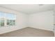 Bright bedroom with neutral carpet and a window offering natural light at 12466 Gust Ct, Hudson, FL 34669