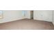 Spacious carpeted bedroom with bright natural light from large windows at 12466 Gust Ct, Hudson, FL 34669