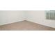Bright bedroom with neutral carpet and a window offering natural light at 12466 Gust Ct, Hudson, FL 34669