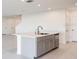 Kitchen island with a sink, faucet, and dishwasher at 12466 Gust Ct, Hudson, FL 34669