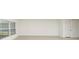 Bright living room with large windows and a door at 12466 Gust Ct, Hudson, FL 34669