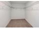 Empty walk-in closet with carpet and white shelving at 12466 Gust Ct, Hudson, FL 34669