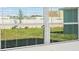 A close-up view of white frame windows that look out to a green lawn at 12466 Gust Ct, Hudson, FL 34669