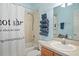 Bathroom with a shower/tub, sink, and towel rack featuring rolled up towels at 13312 Tiger Lilly Ln, Tampa, FL 33625