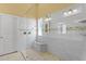 Bright bathroom featuring an open, tiled walk-in shower with a built in bench and decorative tile at 13312 Tiger Lilly Ln, Tampa, FL 33625