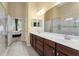 Large bathroom features a double vanity, an open door to the bedroom, and tiled floor at 13312 Tiger Lilly Ln, Tampa, FL 33625