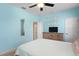 Comfortable bedroom featuring a television, ceiling fan and ample space at 13312 Tiger Lilly Ln, Tampa, FL 33625
