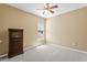 Well-lit bedroom features carpeted floors and a dresser underneath the window at 13312 Tiger Lilly Ln, Tampa, FL 33625