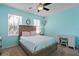 Bright bedroom with a ceiling fan, lots of natural light, and a cozy chair and desk at 13312 Tiger Lilly Ln, Tampa, FL 33625
