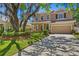 Charming two-story home with attached garage, lush landscaping and beautiful yard at 13312 Tiger Lilly Ln, Tampa, FL 33625