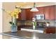 Close-up of a stylish kitchen featuring an island with dark countertops and stainless steel appliances at 13312 Tiger Lilly Ln, Tampa, FL 33625