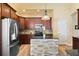 A beautifully-appointed kitchen with stainless appliances and a center island with a stone base at 13312 Tiger Lilly Ln, Tampa, FL 33625