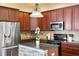Modern kitchen featuring stainless steel appliances, a stylish island, and dark wood cabinetry at 13312 Tiger Lilly Ln, Tampa, FL 33625
