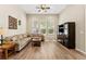 Comfortable living room with hardwood floors and plenty of natural light from large windows at 13312 Tiger Lilly Ln, Tampa, FL 33625