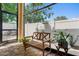 Relaxing screened patio featuring stone flooring, outdoor seating, and a view of the backyard at 13312 Tiger Lilly Ln, Tampa, FL 33625
