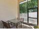 Charming outdoor dining area with a patio table and chairs, offering a view of the backyard at 13312 Tiger Lilly Ln, Tampa, FL 33625