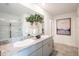 Bathroom featuring a double sink vanity with granite countertop and large mirror at 13357 Tropical Breeze Way, Hudson, FL 34669