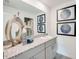 Bathroom featuring a single sink vanity with gray cabinets and granite countertop at 13357 Tropical Breeze Way, Hudson, FL 34669