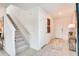 Bright entryway with stairs, neutral tiles, white doors, and a console table at 13357 Tropical Breeze Way, Hudson, FL 34669