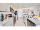 Modern kitchen featuring stainless steel appliances, gray cabinets, and granite countertops at 13357 Tropical Breeze Way, Hudson, FL 34669